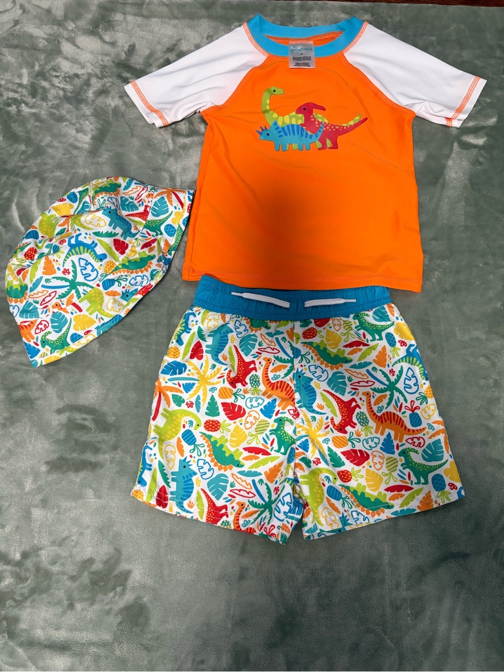 Kids Orange Dino Rash Guard Set with Multicolor Swim Shorts and Hat